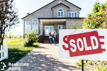 sold house with blurred family on background